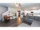Open-concept living room with a large gray sectional, fireplace, and view into kitchen and dining room at 137 Prominence Ct, Canton, GA 30114