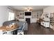 Open-concept living room with a large gray sectional, fireplace, and view into kitchen at 137 Prominence Ct, Canton, GA 30114