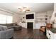Spacious living room with a cozy gray sectional sofa, fireplace, built-in shelves, and hardwood flooring at 137 Prominence Ct, Canton, GA 30114