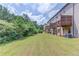 View of townhome rear elevations with backyard, decks, and trees, enhancing outdoor living at 2005 Hamilton Creek Pkwy, Dacula, GA 30019