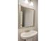 Bathroom features a modern pedestal sink, vanity mirror, and sconce lighting at 2005 Hamilton Creek Pkwy, Dacula, GA 30019