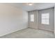 Bright bedroom with neutral carpet and two windows at 2005 Hamilton Creek Pkwy, Dacula, GA 30019