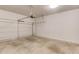 Clean, empty two-car garage with white walls and concrete floor, ready for parking and storage at 2005 Hamilton Creek Pkwy, Dacula, GA 30019