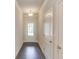 Inviting entryway boasting hardwood floors, neutral paint, and a glass paneled front door at 2005 Hamilton Creek Pkwy, Dacula, GA 30019