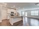 Open-concept kitchen featuring a granite island, stainless steel appliances, and hardwood flooring at 2005 Hamilton Creek Pkwy, Dacula, GA 30019