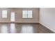 Bright, open living room features hardwood floors, white trim, and abundant natural light at 2005 Hamilton Creek Pkwy, Dacula, GA 30019