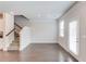 Open-concept living room features hardwood floors, stairs, and a sliding glass door at 2005 Hamilton Creek Pkwy, Dacula, GA 30019