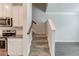 This home features a staircase leading to the upper level, adjacent to the well-equipped kitchen at 2005 Hamilton Creek Pkwy, Dacula, GA 30019