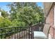 View from balcony features wrought iron railing and overlooks lush greenery, offering a relaxing outdoor space at 3675 Peachtree Ne Rd # 24, Atlanta, GA 30319