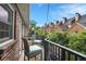 Cozy balcony with seating offers views of neighboring townhomes and a sunny sky, perfect for relaxing outdoors at 3675 Peachtree Ne Rd # 24, Atlanta, GA 30319