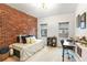 Cozy bedroom featuring a brick accent wall, bright windows, and a comfortable daybed at 3675 Peachtree Ne Rd # 24, Atlanta, GA 30319