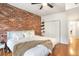 This bedroom offers a brick wall, hardwood floors, and a large closet at 3675 Peachtree Ne Rd # 24, Atlanta, GA 30319