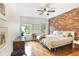 This bedroom offers a brick wall, hardwood floors, and plenty of natural light at 3675 Peachtree Ne Rd # 24, Atlanta, GA 30319