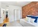 The bedroom boasts a striking brick accent wall and a comfortable seating area at 3675 Peachtree Ne Rd # 24, Atlanta, GA 30319