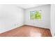 Bright bedroom featuring wood floors, fresh paint, and a window with a green view at 1308 Camelot Dr, Atlanta, GA 30349