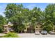 Apartment building with Tudor architecture, mature trees, and ample parking available at 1308 Camelot Dr, Atlanta, GA 30349
