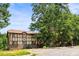 Inviting two-story home showcasing its unique Tudor style and mature trees in a tranquil setting at 1308 Camelot Dr, Atlanta, GA 30349