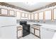 Efficient kitchen with ample counter space, white appliances, and practical layout for easy cooking at 1308 Camelot Dr, Atlanta, GA 30349