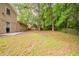 Expansive backyard featuring lush greenery, mature trees, and an inviting outdoor space at 2233 Cherokee Valley Dr, Lithonia, GA 30058