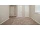 Neutral bedroom with carpet flooring and several closet and doorway options at 2233 Cherokee Valley Dr, Lithonia, GA 30058
