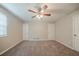 Spacious bedroom featuring a ceiling fan, neutral paint, carpet flooring, and natural light at 2233 Cherokee Valley Dr, Lithonia, GA 30058