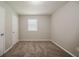 Empty bedroom with neutral paint, carpet flooring, and a window at 2233 Cherokee Valley Dr, Lithonia, GA 30058