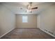 Spacious bedroom features soft carpet, overhead ceiling fan, and a bright window at 2233 Cherokee Valley Dr, Lithonia, GA 30058