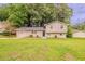Charming two-story home with well-maintained lawn and inviting curb appeal nestled amongst mature trees at 2233 Cherokee Valley Dr, Lithonia, GA 30058