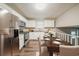 Bright kitchen features stainless steel appliances, white cabinets and a charming dining table at 2233 Cherokee Valley Dr, Lithonia, GA 30058