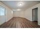 Large room featuring wood-look floors, fireplace, a door to outside, and access to another room at 2233 Cherokee Valley Dr, Lithonia, GA 30058