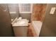 Cozy bathroom featuring a tiled shower and floors, a window, and a vanity with a granite countertop at 3873 Jane Marie Ln, Decatur, GA 30035