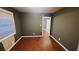 Inviting bedroom with hardwood floors, neutral paint, and a large window at 3873 Jane Marie Ln, Decatur, GA 30035