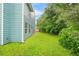 A view of the expansive backyard with a view of the home's exterior at 4753 Klondike Cv, Lithonia, GA 30038