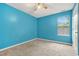 Bright bedroom featuring neutral carpet, a ceiling fan, and a sunlit window at 4753 Klondike Cv, Lithonia, GA 30038