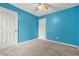 Vibrant bedroom with blue walls, neutral carpeting and bright light fixtures at 4753 Klondike Cv, Lithonia, GA 30038