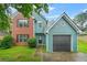 Charming two-story home with a brick facade and blue siding and a well-maintained lawn at 4753 Klondike Cv, Lithonia, GA 30038