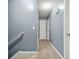 Upstairs hallway featuring neutral carpet leading to a stairway and doors at 4753 Klondike Cv, Lithonia, GA 30038