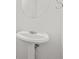 Close-up of a white pedestal sink and round mirror in a powder room at 4753 Klondike Cv, Lithonia, GA 30038