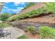 A cozy backyard featuring a stone retaining wall and a private patio area perfect for outdoor relaxation and entertaining at 936 Village View Cir, Loganville, GA 30052