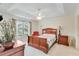 Cozy bedroom featuring a wood sleigh bed and a ceiling fan at 936 Village View Cir, Loganville, GA 30052