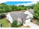 Aerial view of a home with a brick facade, manicured lawn, and mature landscaping, offering an inviting curb appeal at 936 Village View Cir, Loganville, GA 30052