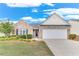 Charming single-story home with a well-manicured lawn, brick facade, and two-car garage at 936 Village View Cir, Loganville, GA 30052