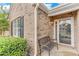 Welcoming front porch with a bench, a seasonal wreath on the front door, and a well-kept garden at 936 Village View Cir, Loganville, GA 30052