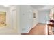 Bright hallway featuring hardwood floors, neutral paint, and access to the bathroom at 936 Village View Cir, Loganville, GA 30052
