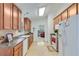 Well-lit kitchen with tile floor, wooden cabinets, and stainless steel appliances at 936 Village View Cir, Loganville, GA 30052