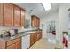 Bright kitchen featuring wood cabinets, tile backsplash, and modern appliances at 936 Village View Cir, Loganville, GA 30052