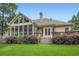 Back exterior with a screened-in porch and deck with trees, plants, and grass at 2676 Varner Ne Dr, Atlanta, GA 30345