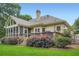 Back of house featuring a screened porch and deck overlooking a lush, landscaped yard at 2676 Varner Ne Dr, Atlanta, GA 30345