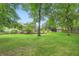 Large, well-maintained backyard with trees and manicured garden, and the back of the house at 2676 Varner Ne Dr, Atlanta, GA 30345