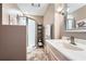Well-lit bathroom featuring modern vanity, glass shower, decor shelving, and neutral finishes at 2676 Varner Ne Dr, Atlanta, GA 30345
